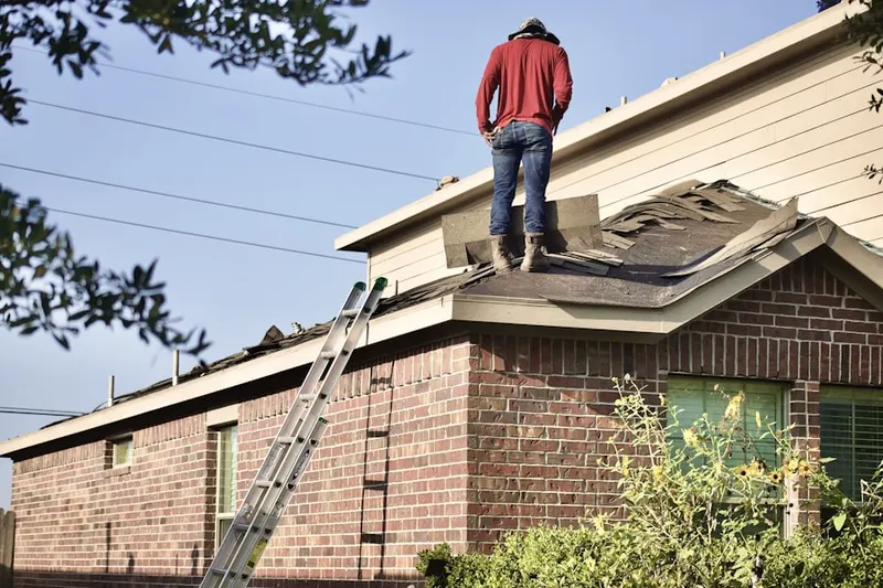 Professional roofer working on a residential roof in Pensacola Station
